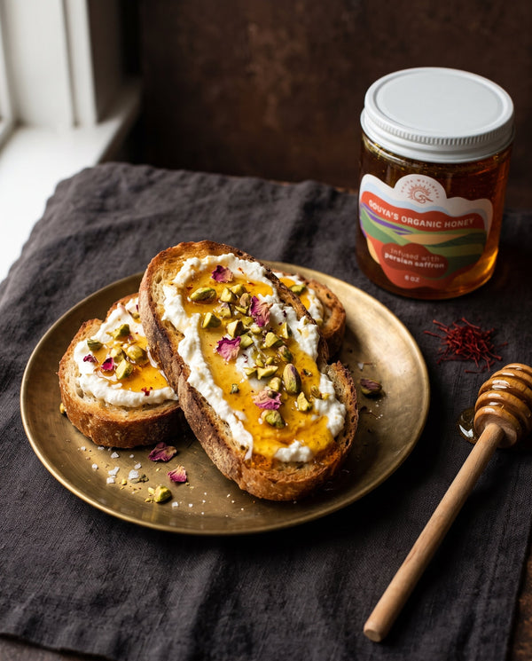 Saffron honey ricotta toast topped with pistachios and rose petals