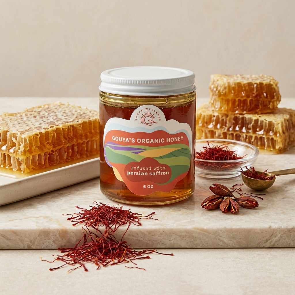 Saffron honey jar on a marble slab with honeycomb, saffron threads and a small bowl of saffron