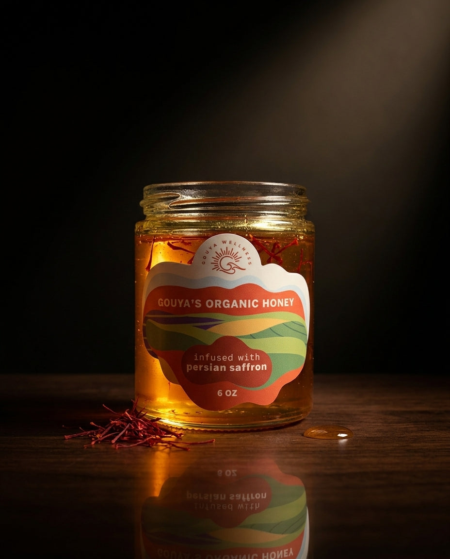 Saffron honey jar in dramatic low light with scattered saffron threads