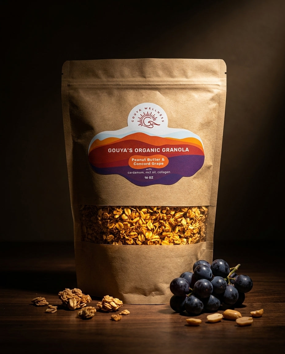 Gouya granola bag in low light with Concord grapes and scattered nuts