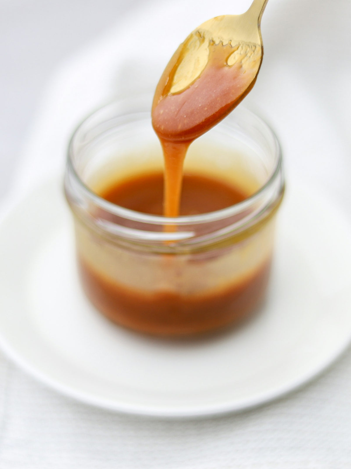 Persian saffron threads beside a jar of Gouya saffron honey